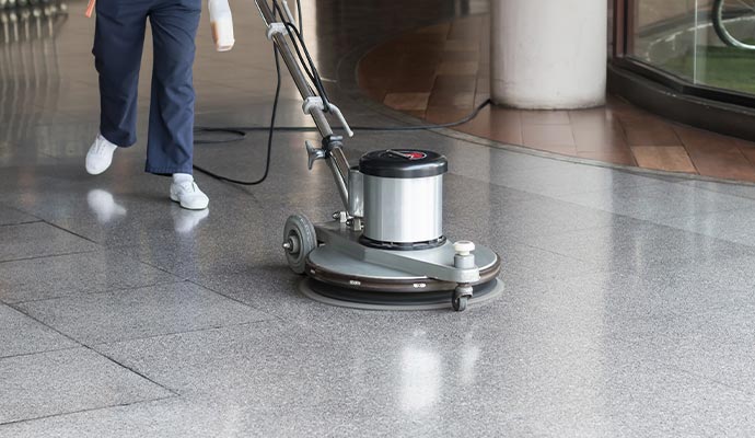 Professional worker cleaning commercial floor