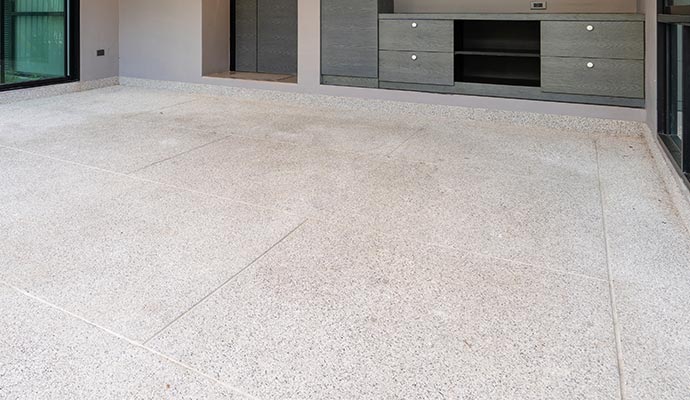 Professional worker cleaning concrete floor