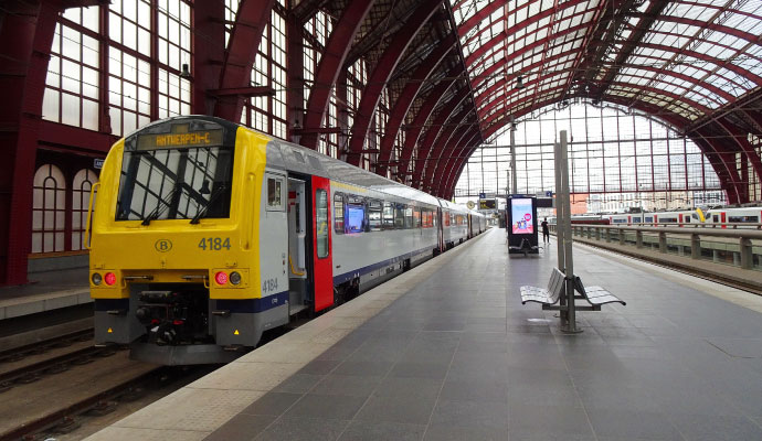 A passenger train stopped at a platform inside a train station