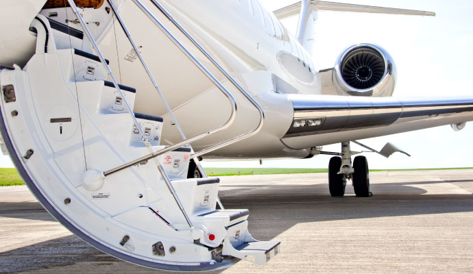 A white private jet's deployed entrance