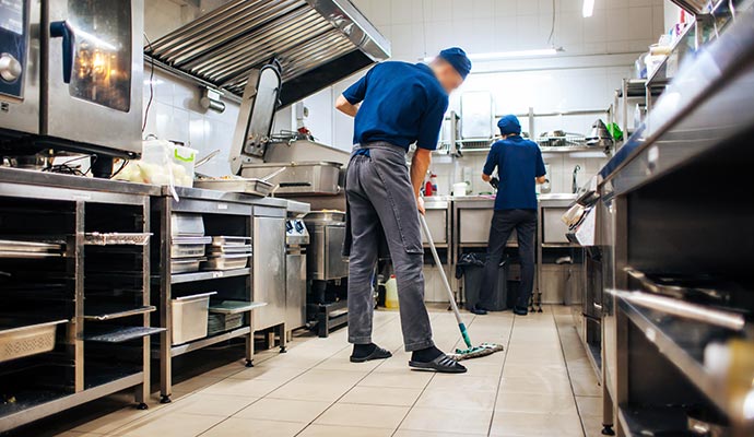 Professional worker cleaning kitchen