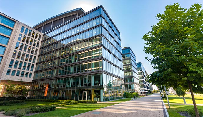 Modern commercial building complex with landscaped walkway