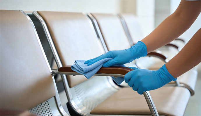 Person cleaning waiting room chairs