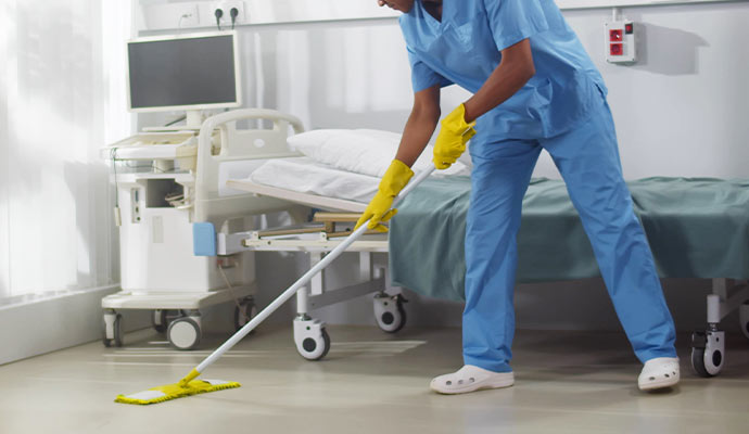 Professional cleaning the floor in a hospital room floor.
