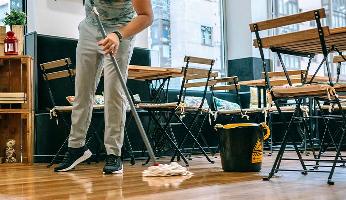 Professional worker cleaning restaurant