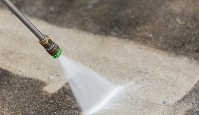 Expert cleaning parking lot with pressure washing