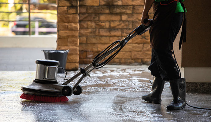 Floor scrubbing on an outdoor commercial surface