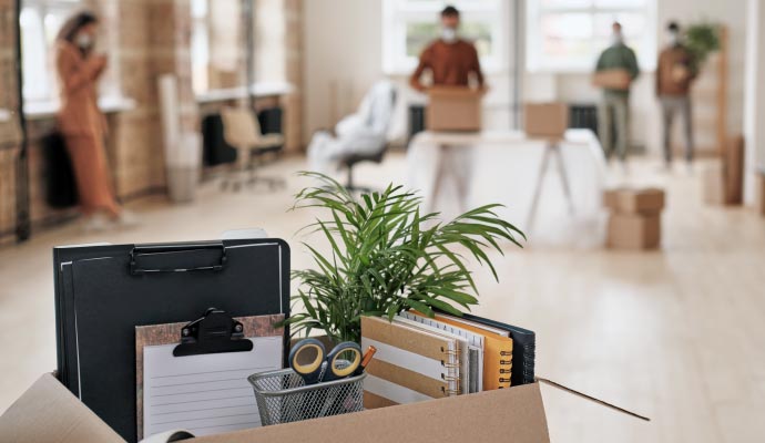 Packed office supplies in a box during vacancy cleaning
