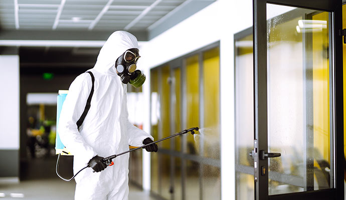 Person disinfecting glass door