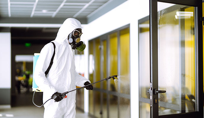 Spraying disinfectant on an glass door