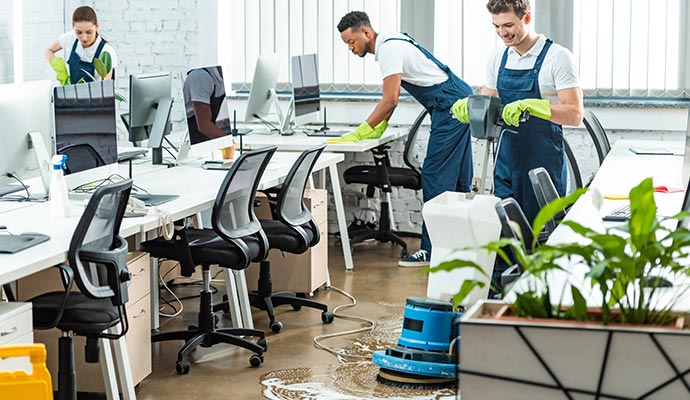 Professional cleaning team deep cleaning a modern office
