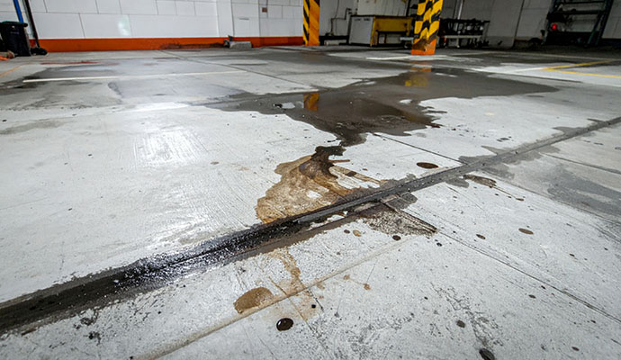 Oil and grease spill on concrete floor
