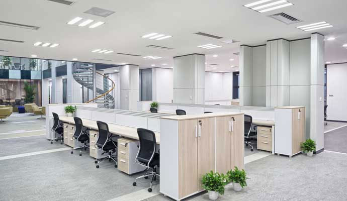 Clean modern office workstations with desks and chairs