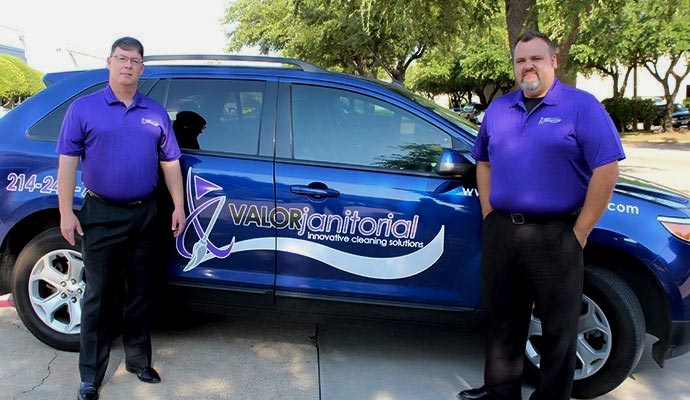 Valor Janitorial service providers standing in front of their service van